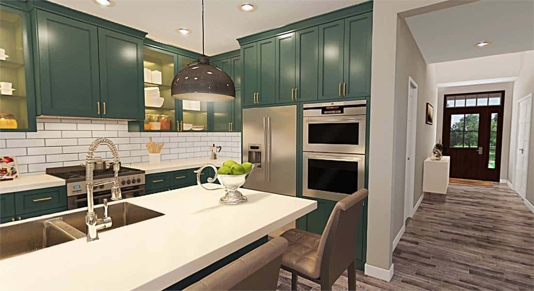 Kitchen with stainless steel appliances, green cabinetry, and a breakfast island fitted with double sinks.