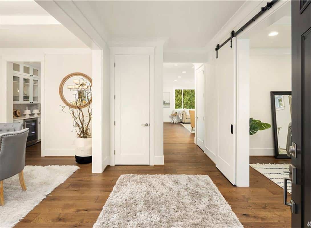Foyer with a coat closet situated in between the formal dining room and the den.
