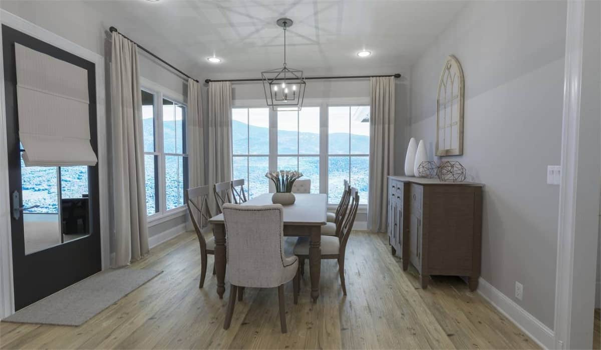 Dining room with a wooden buffet table, a matching dining set, and back porch access via a glazed door.