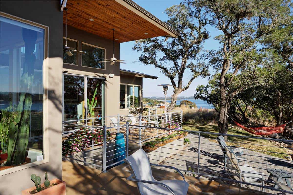 The covered deck transitions to a concrete patio perfect for entertaining.