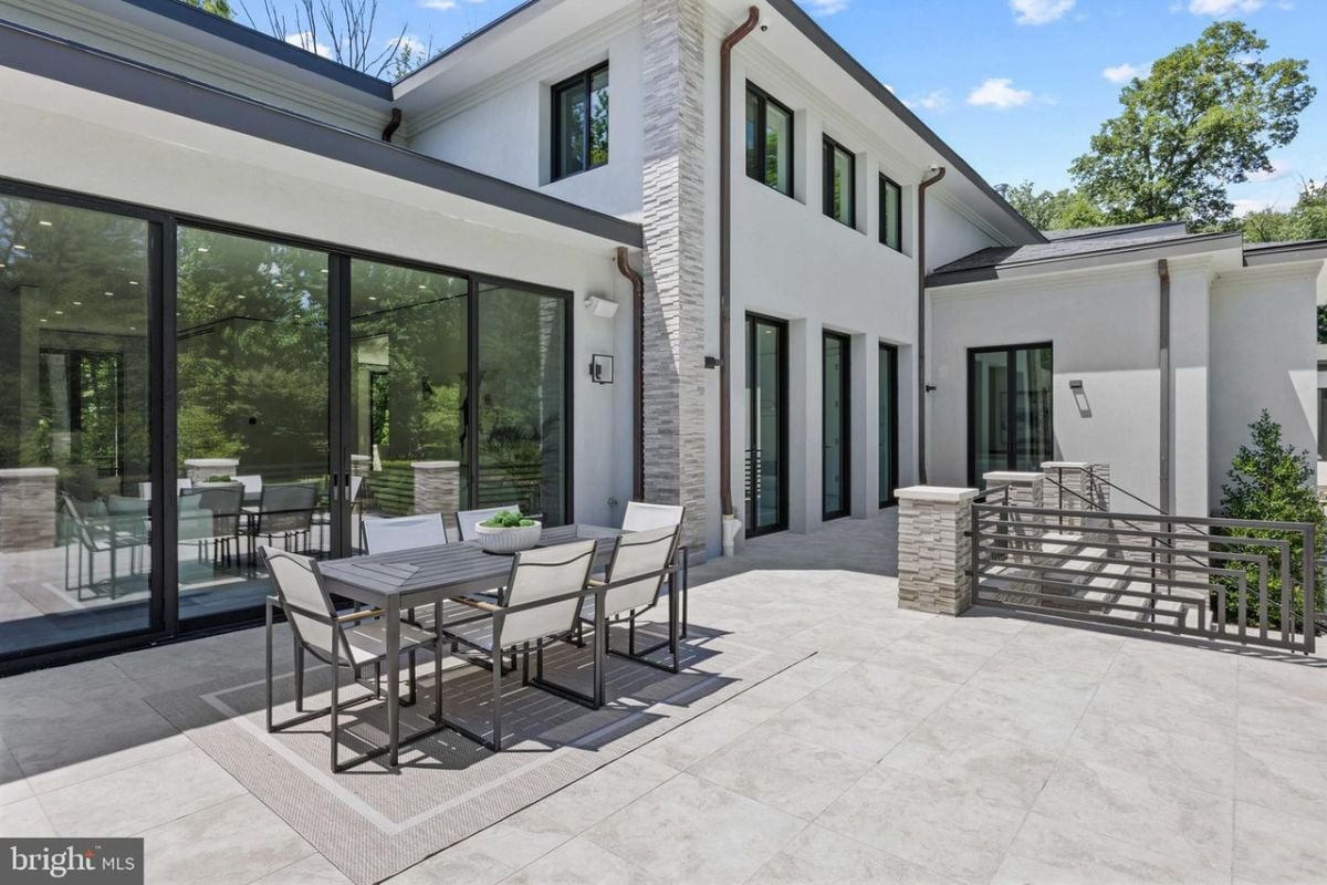 A patio with a table and chairs.