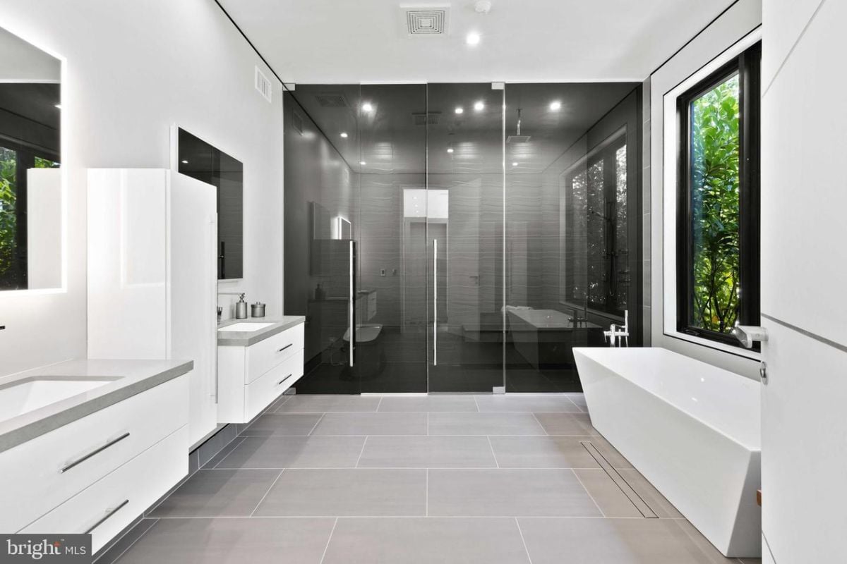 A bathroom with a shower room and a sink.
