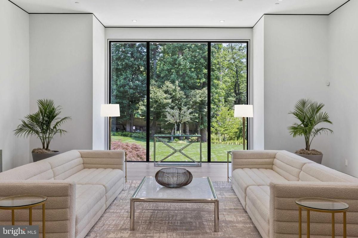 A living room with a large glass wall.