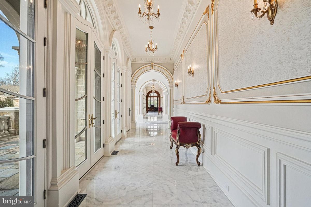 Hallway is lined with marble flooring and ornate gold trim.