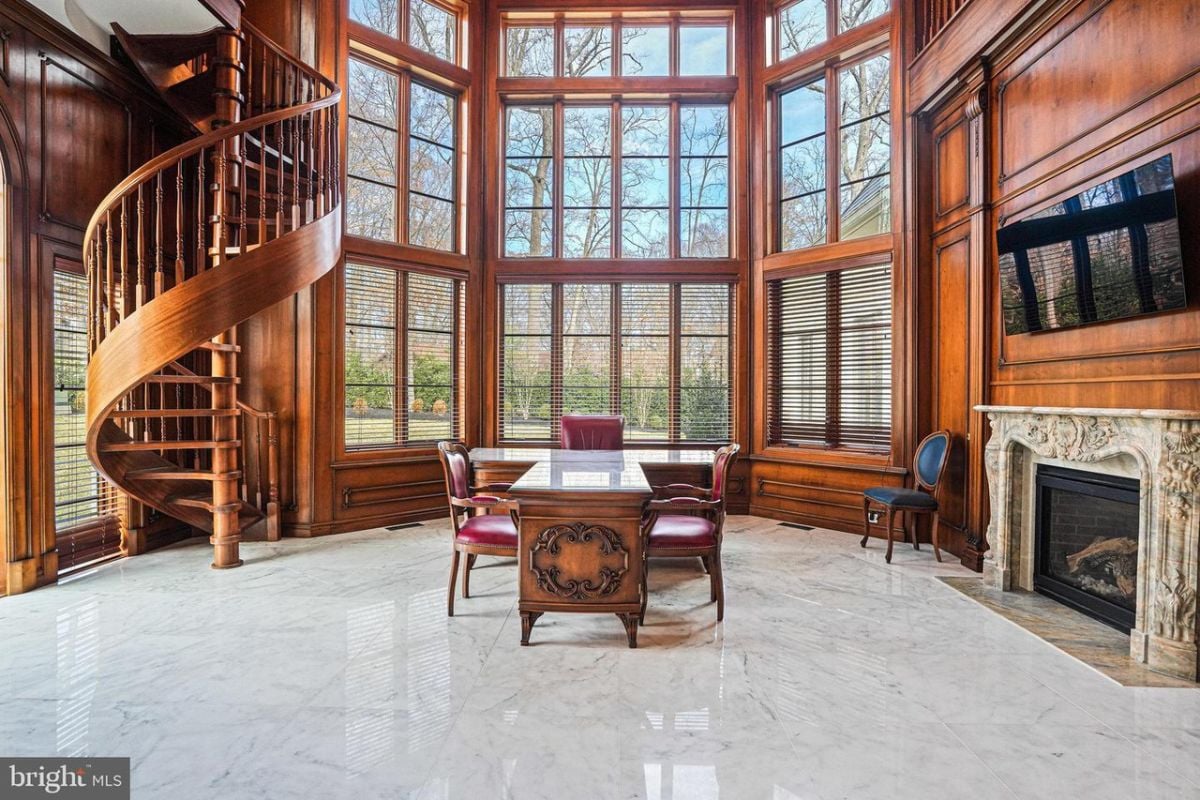 Spacious Home office with a spiral staircase and a fireplace.