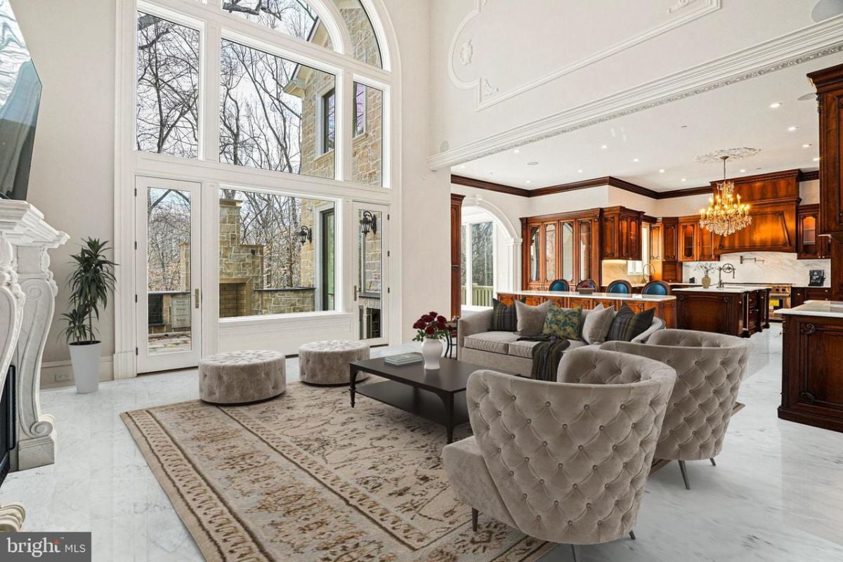 Spacious living room with a large arched window.