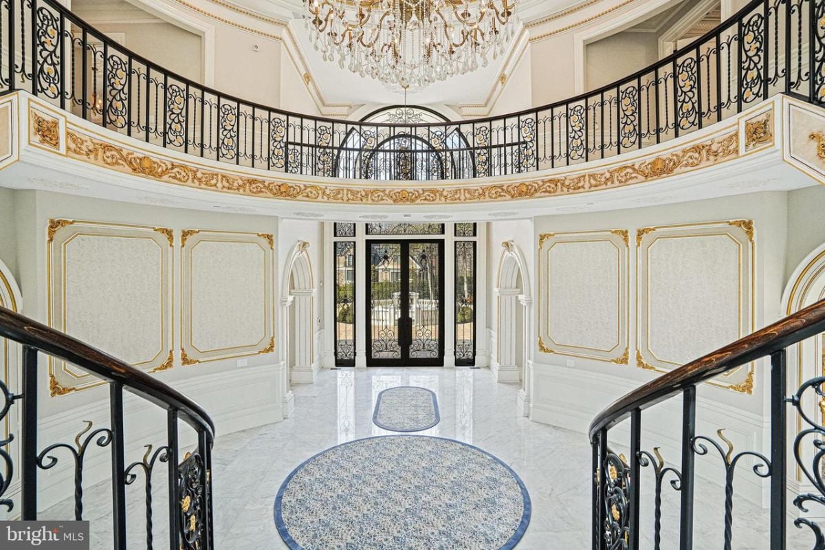 Foyer is lined with marble floors and ornate chandeliers.