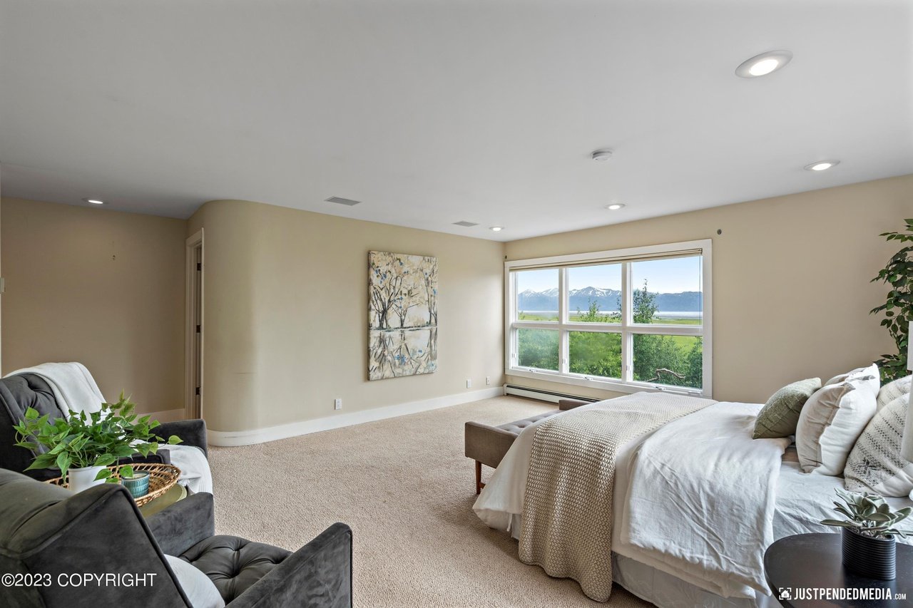 Master bedroom with a large bed and a large window.