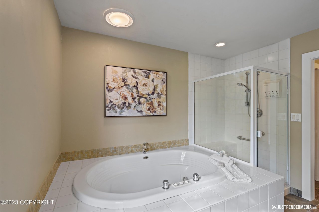Bathroom with a large tub and a walk in shower.