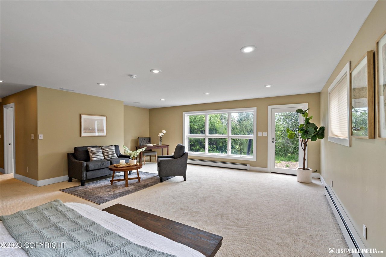 A bedroom with couches and table.