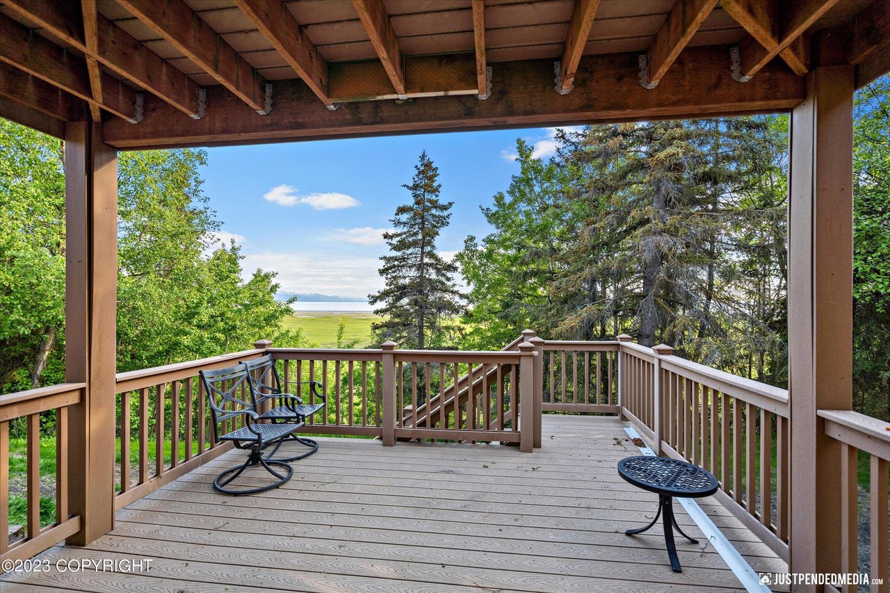 Deck with chairs and a view of the ocean.