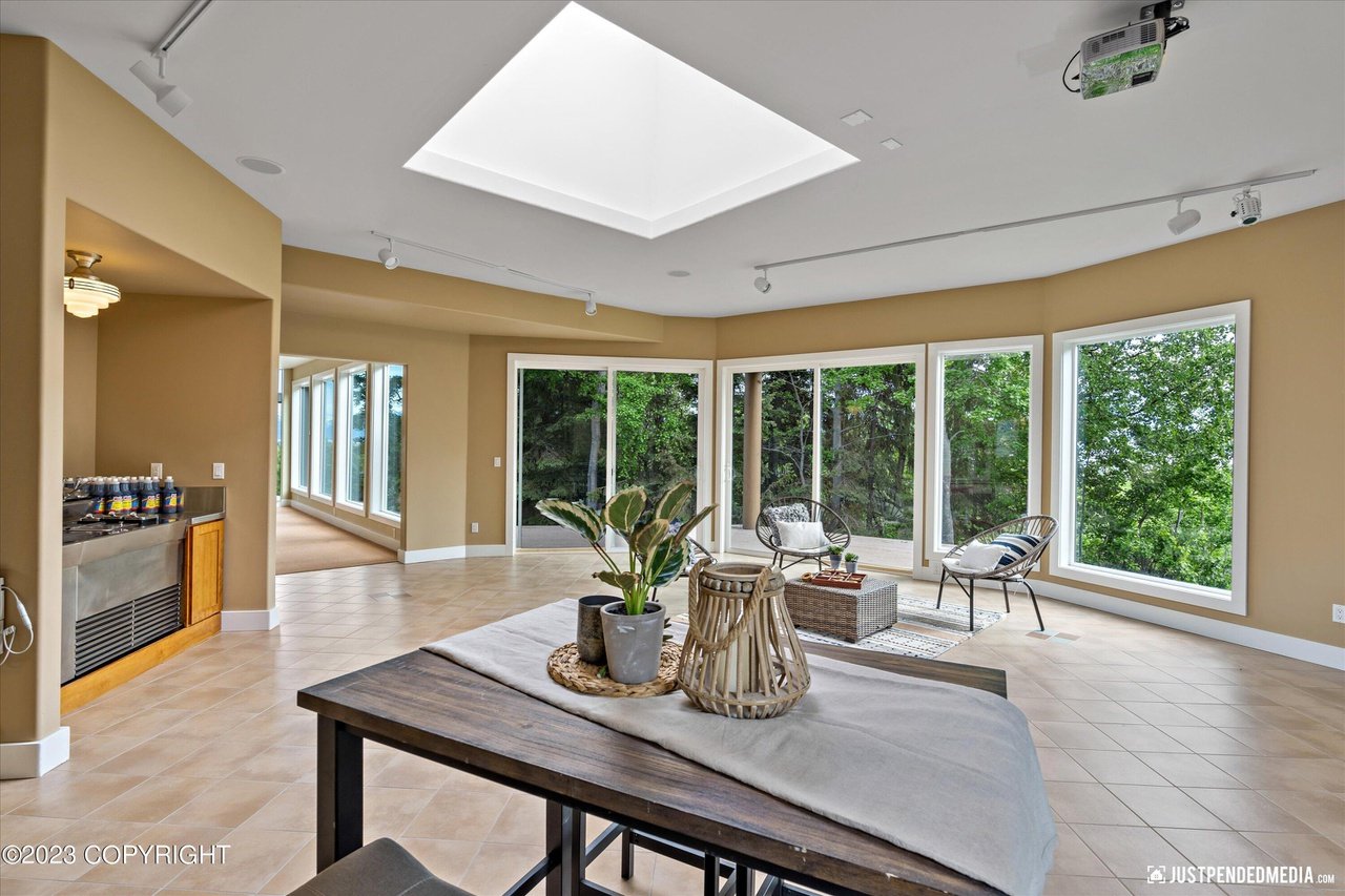 A room with a skylight and a table.