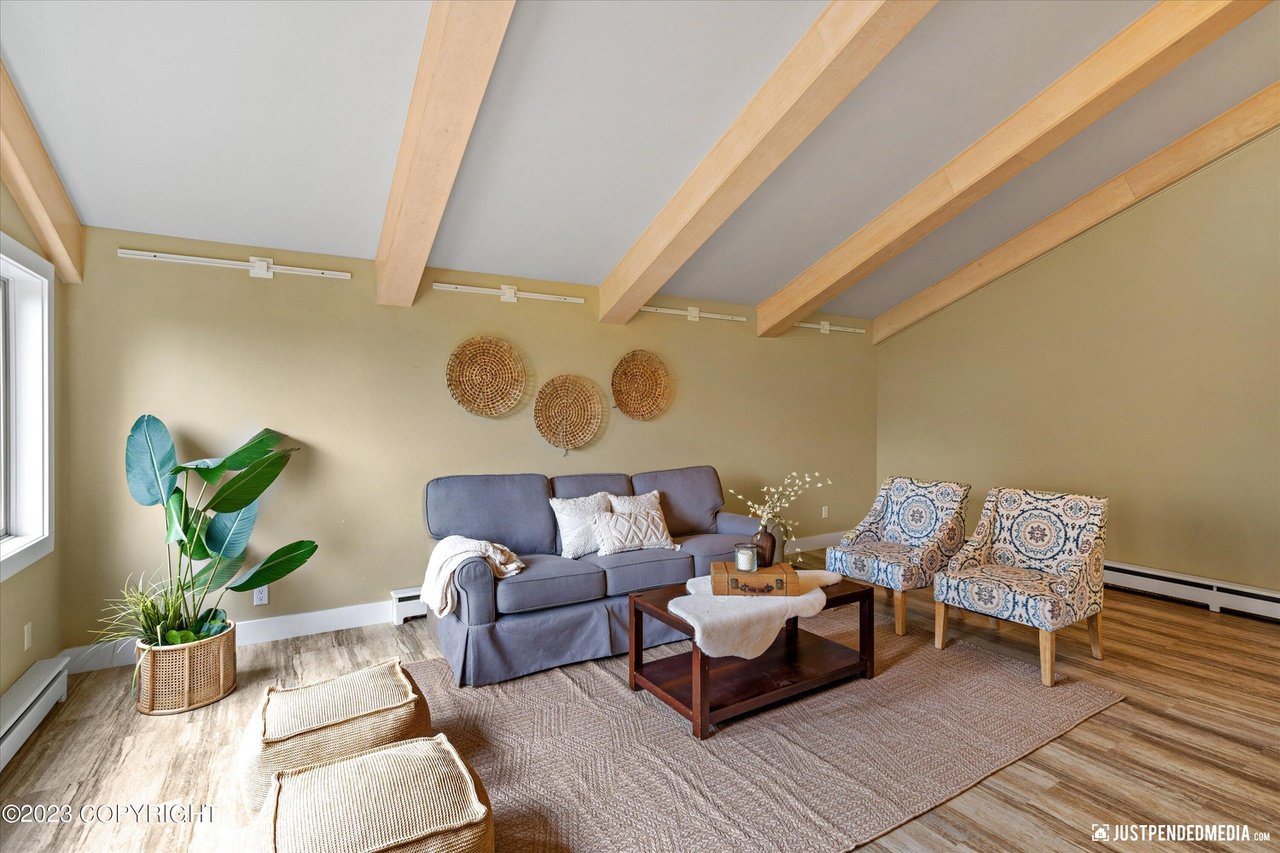 A living room with a couch, chair and a coffee table.