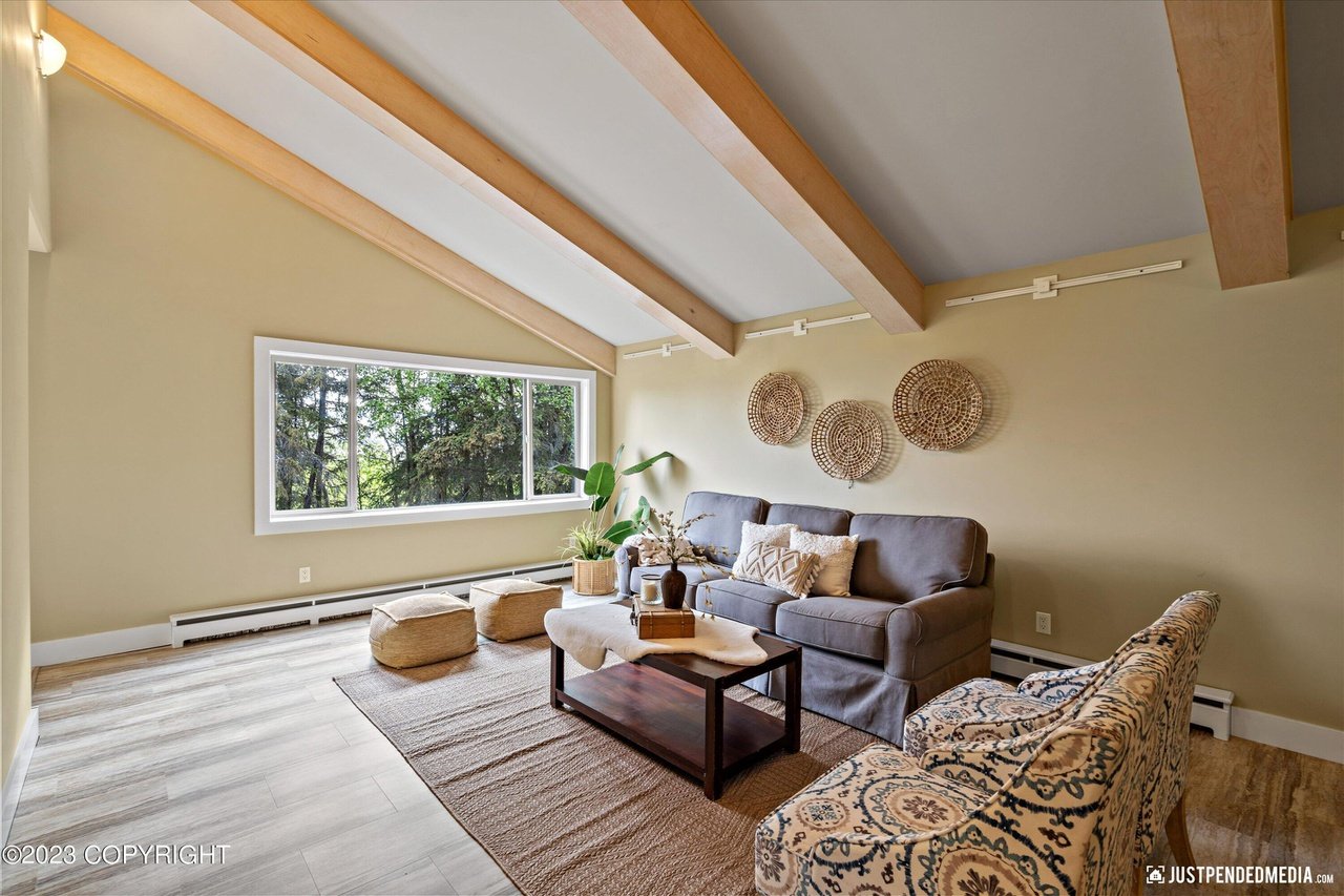 A living room with a couch, chair and a coffee table.