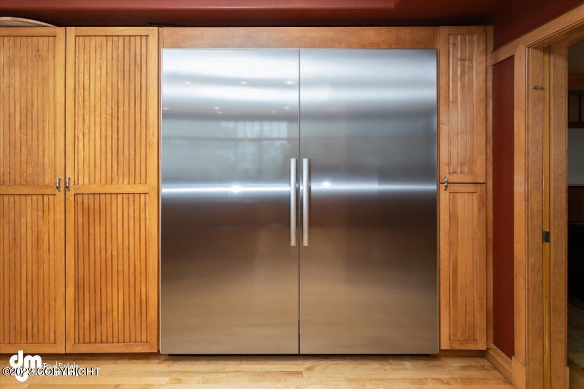 Kitchen with a stainless refrigerator and wooden cabinets.