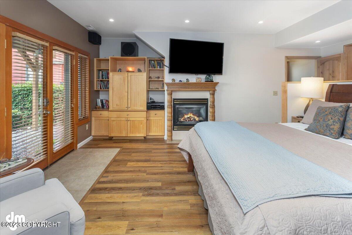 A bedroom with a fireplace and a television.