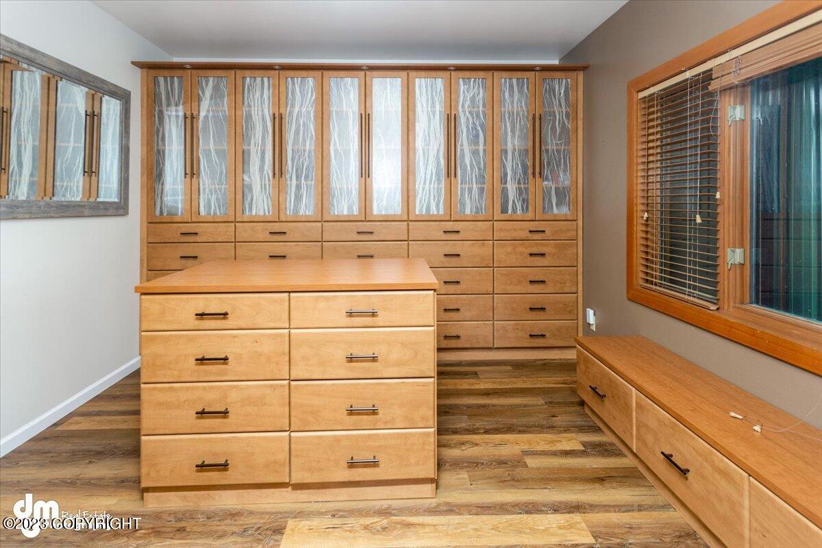 A room with a wooden cabinet and a window.