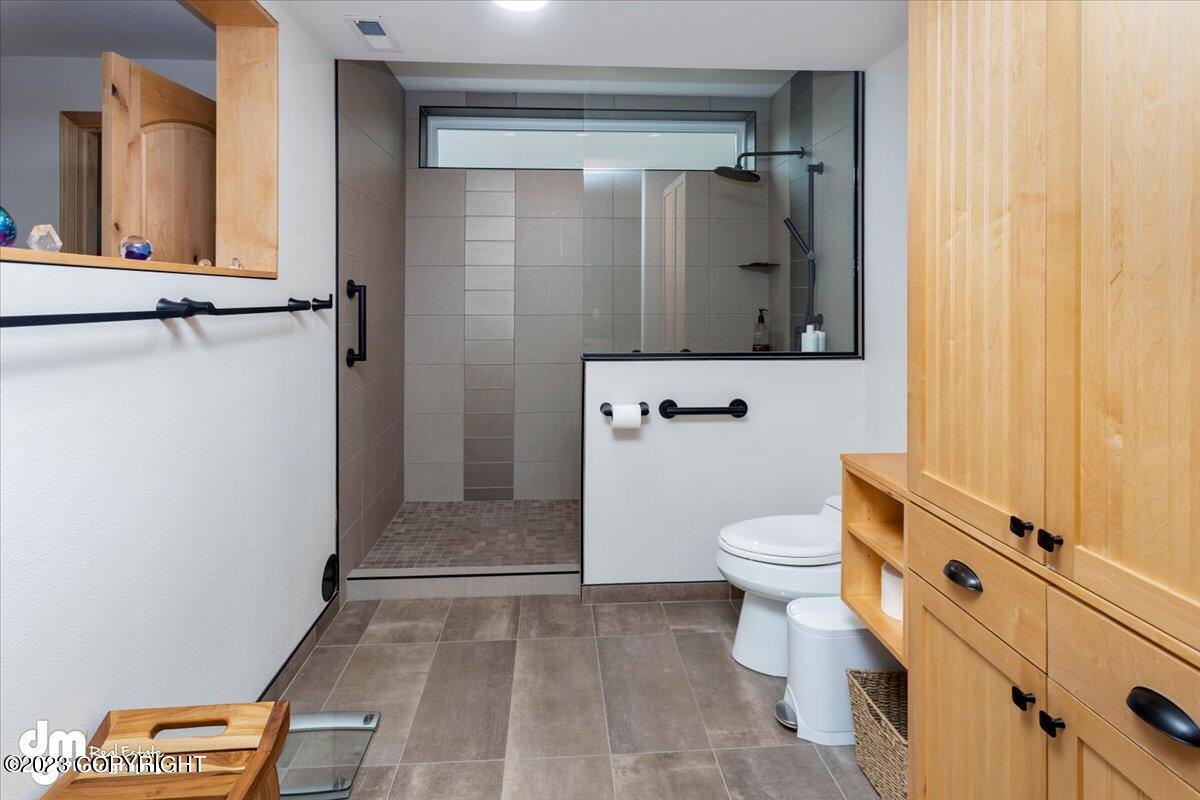 Bathroom with a shower and a glass door.