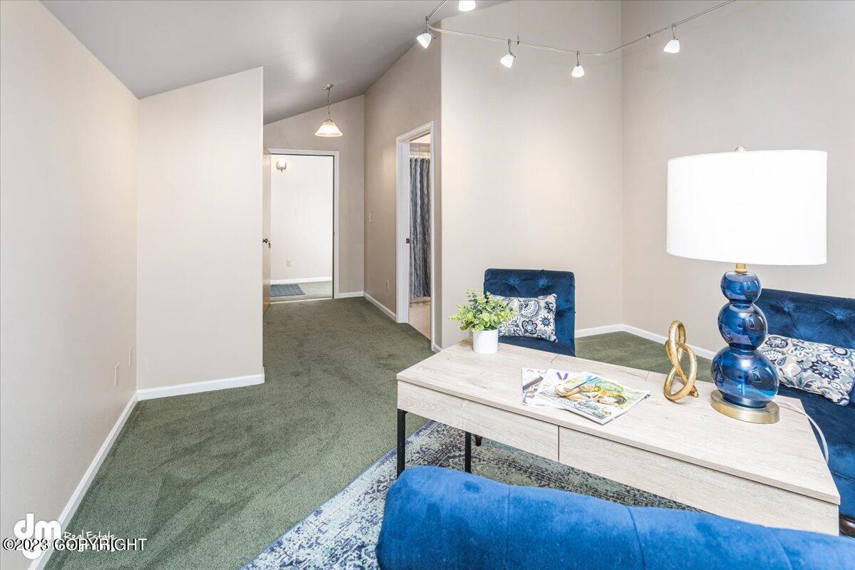A living room with blue couches and a white ceiling.