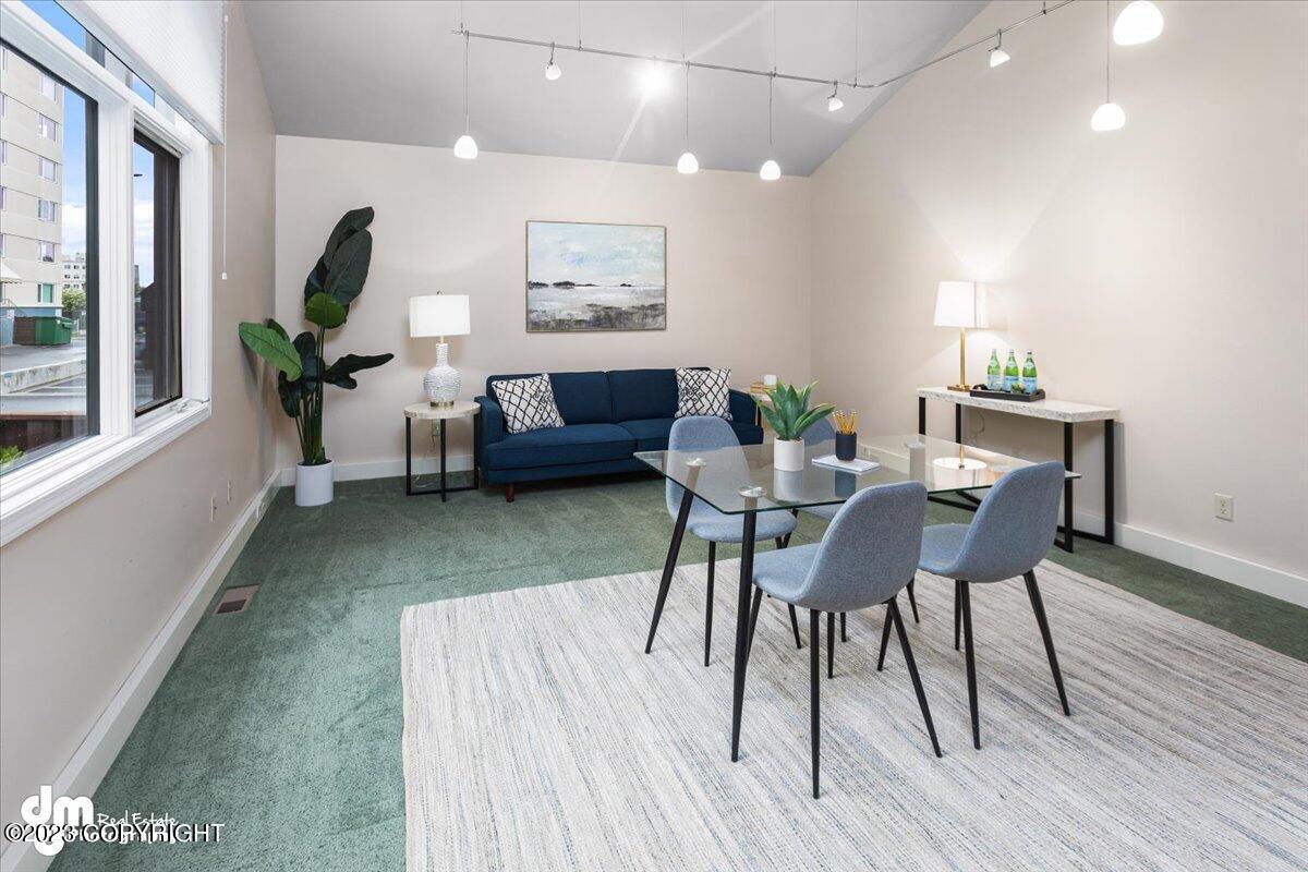 Small dining table with a couch, table and chairs.