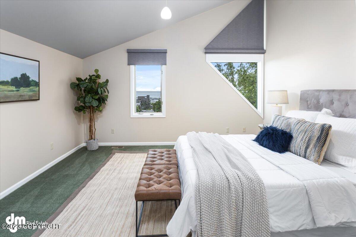 A bedroom with a large bed and a window.