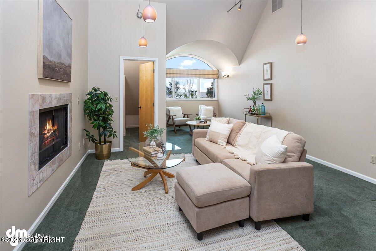 Living room with a couch, chair and fireplace.