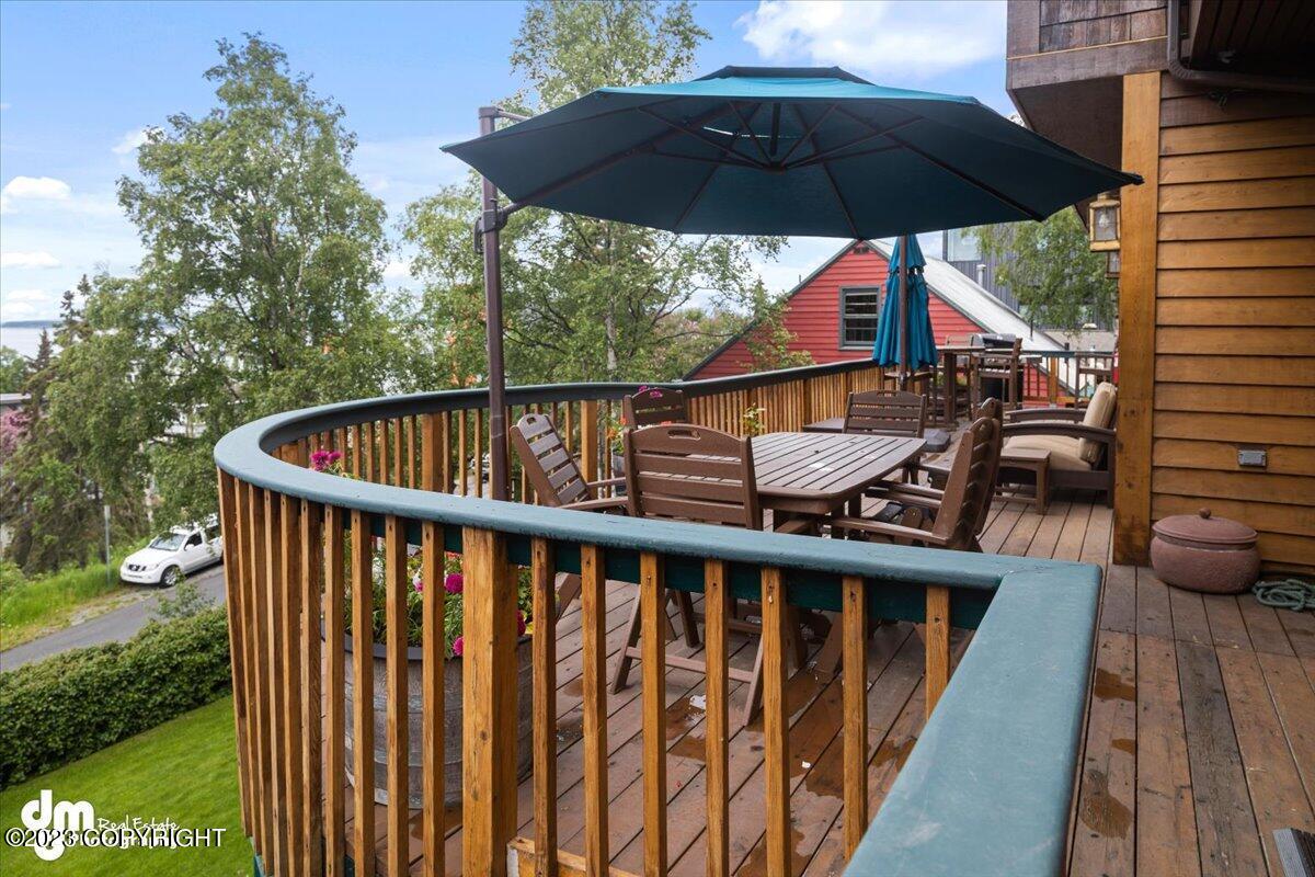 A deck with table, chairs and umbrella.
