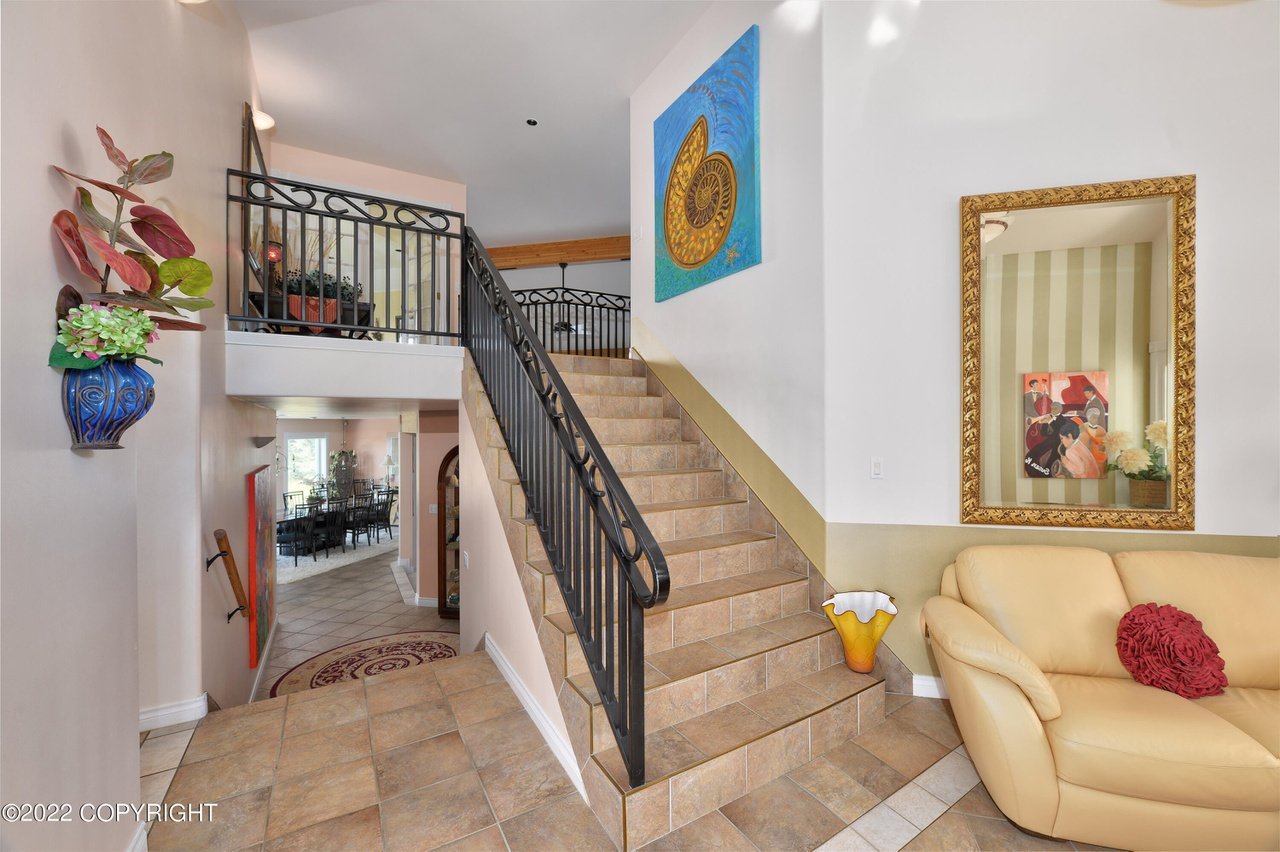 A staircase with tile floor and metal railing.