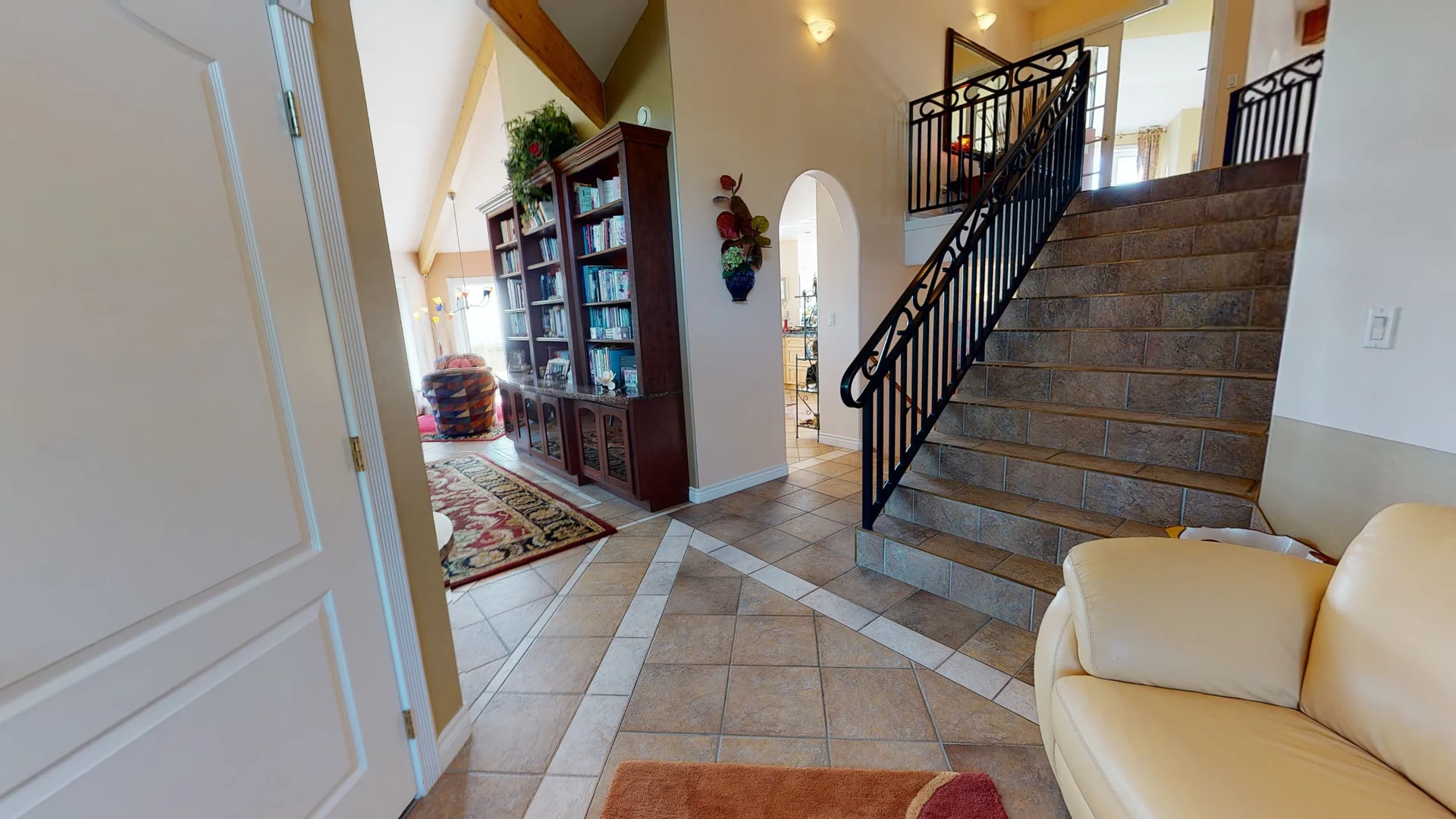 A living room with a couch and stairs.