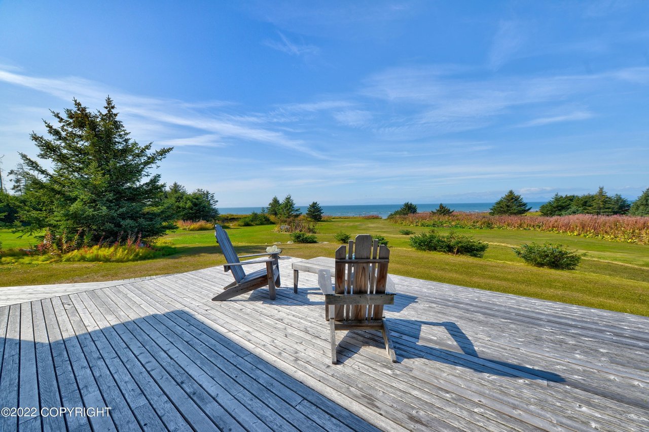 A deck with chairs overlooking the ocean