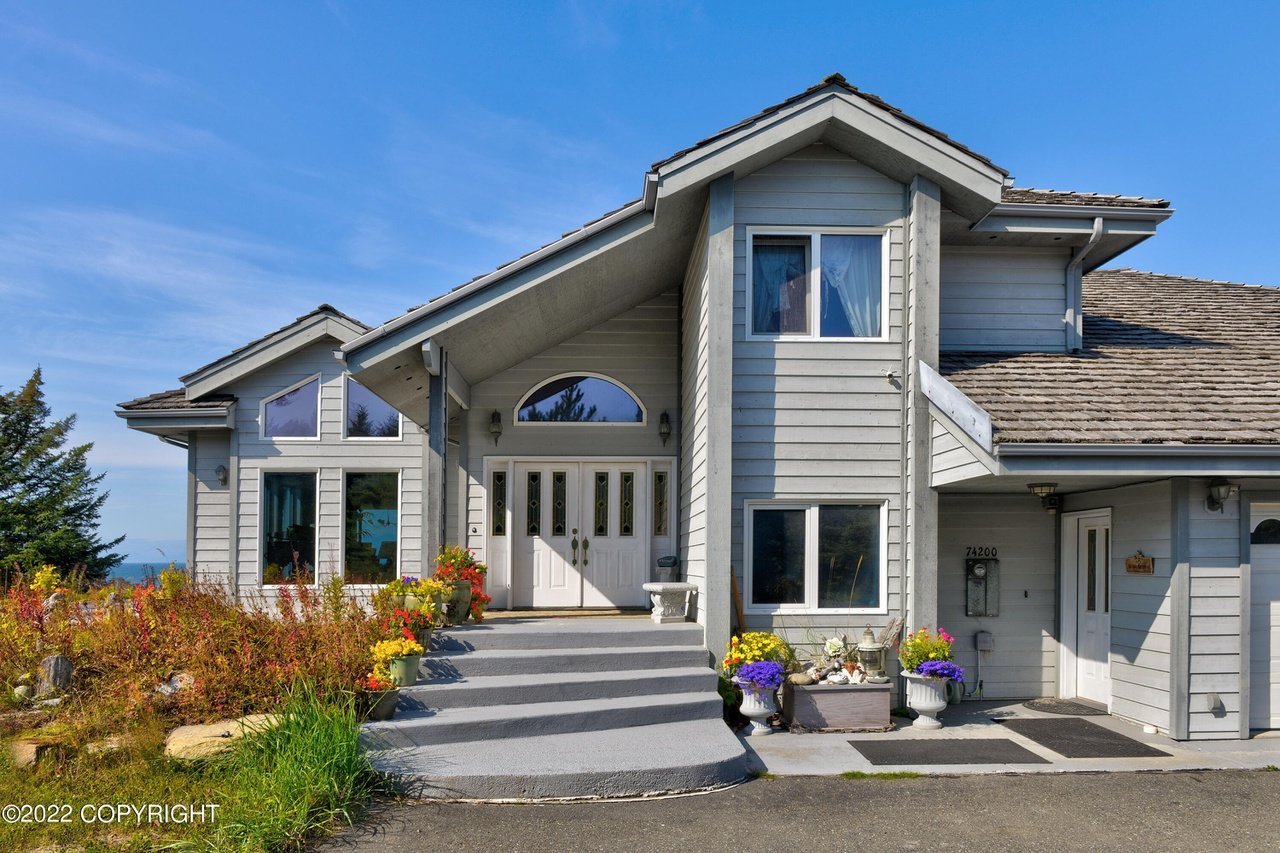 House's large main door and a huge driveway.