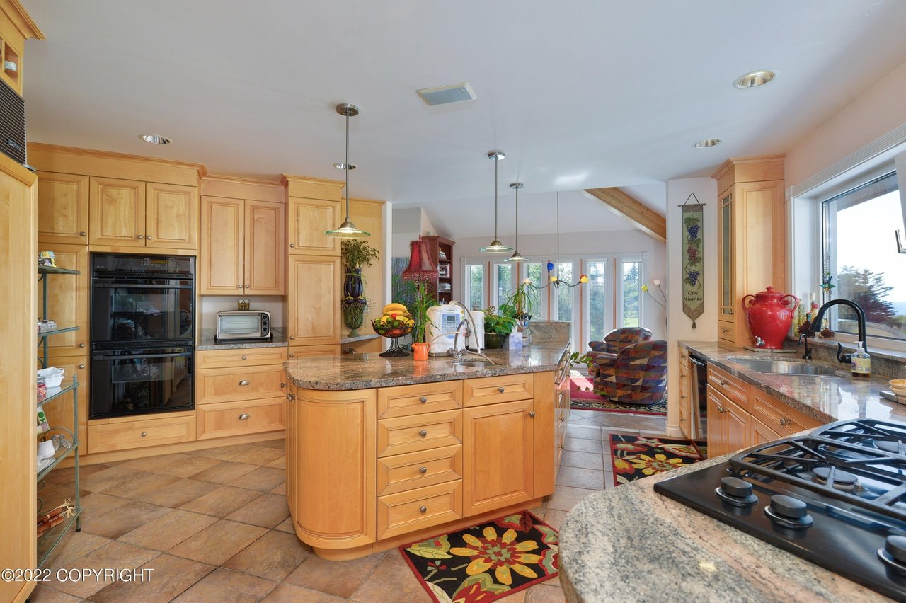 A kitchen with a stove and a sink.