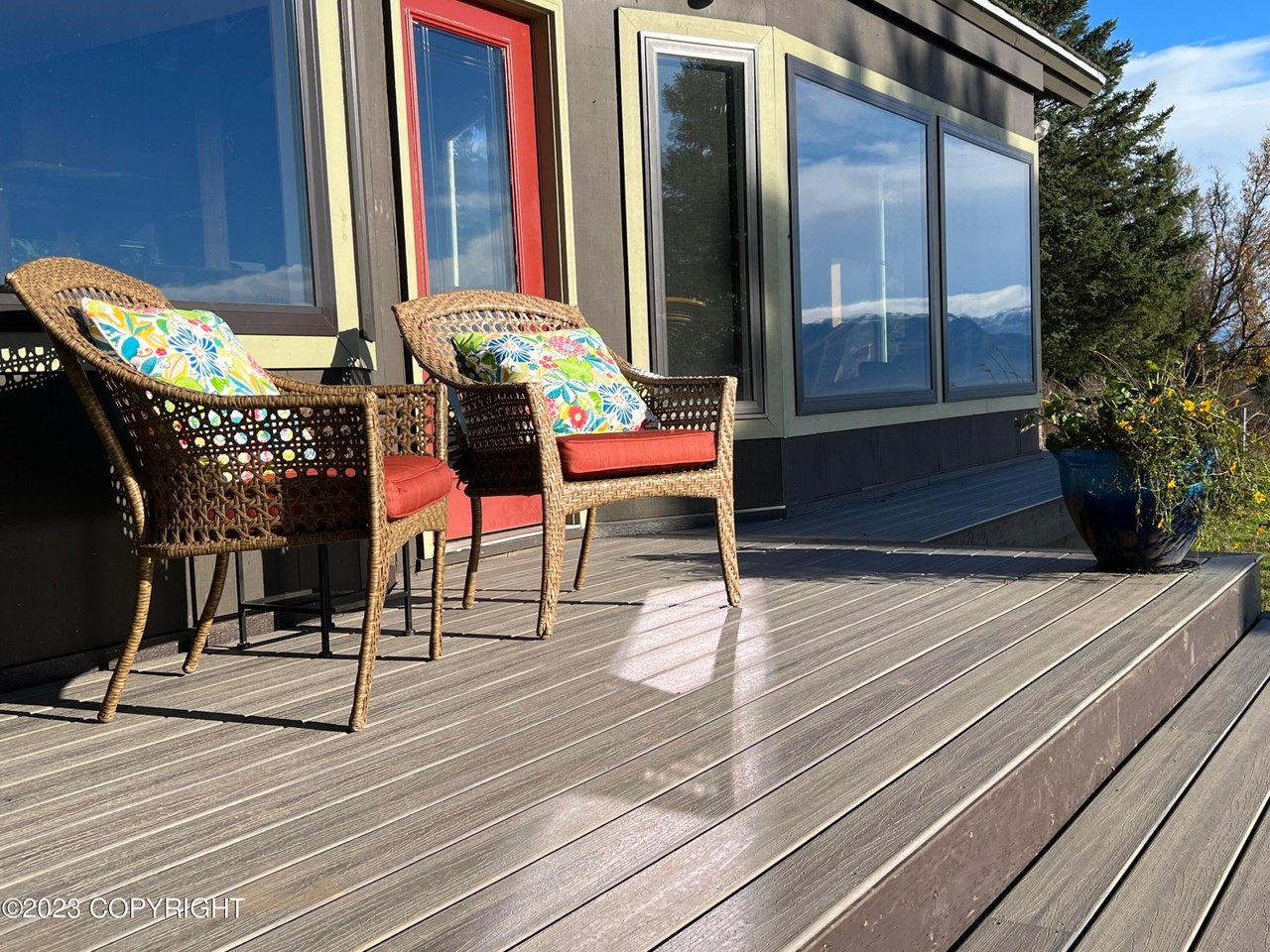 A wooden deck with chairs.