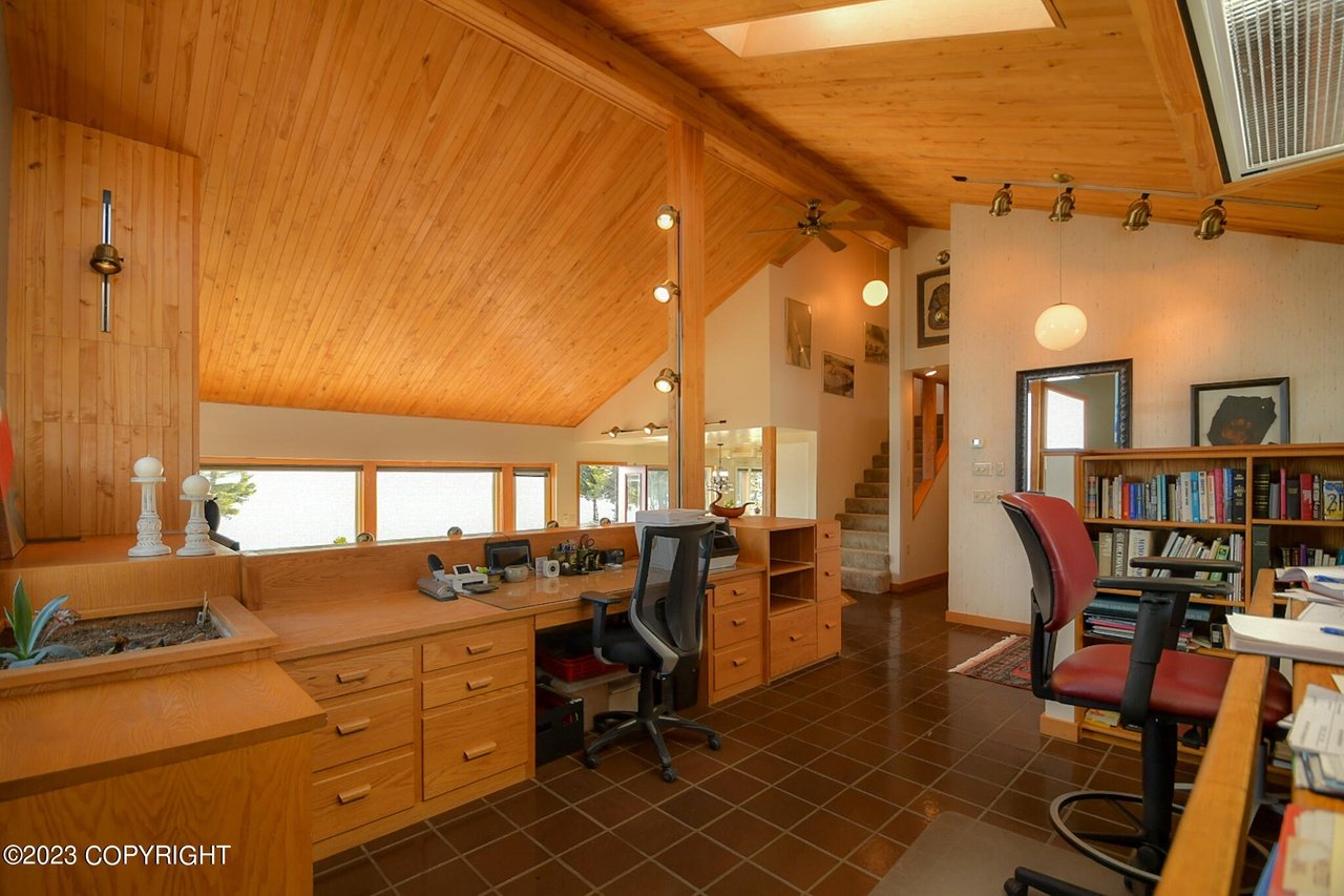 Home office with desks and chairs.