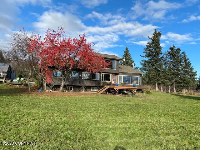 A house with a tree in the yard.