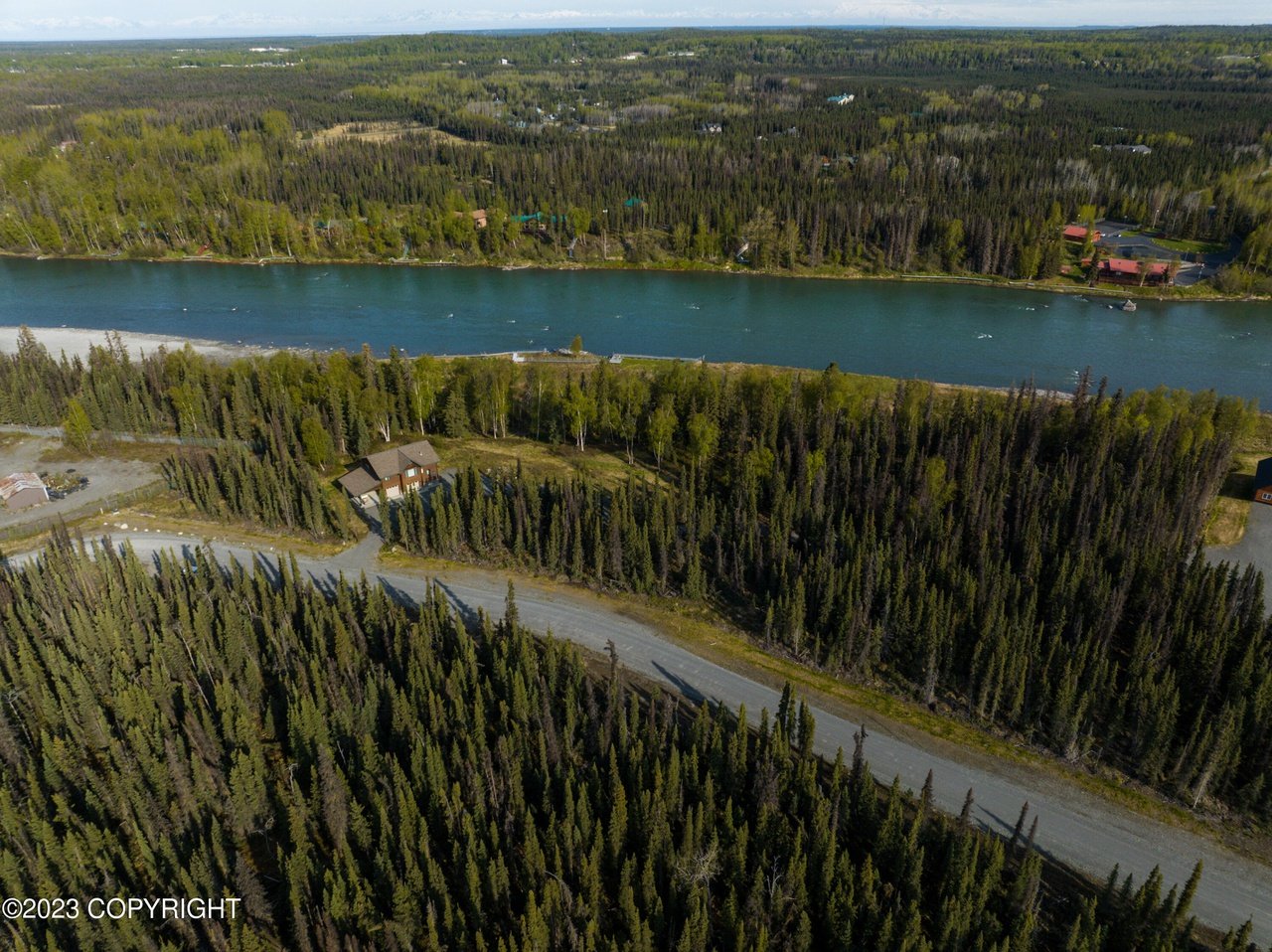 Aerial view of the house with a river on the background.