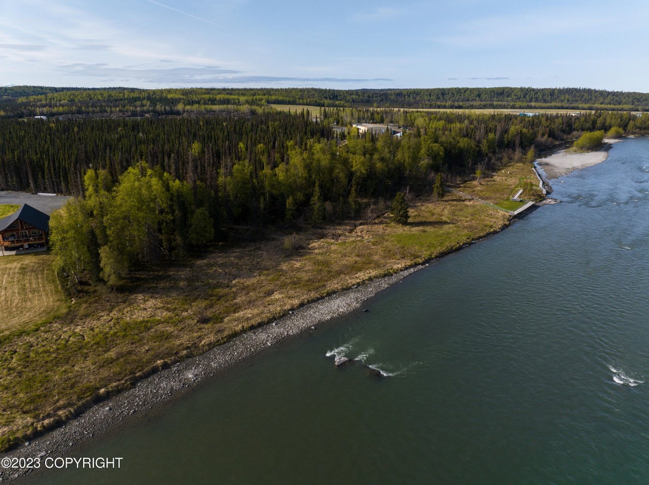 Aerial view of the real estate with a river.