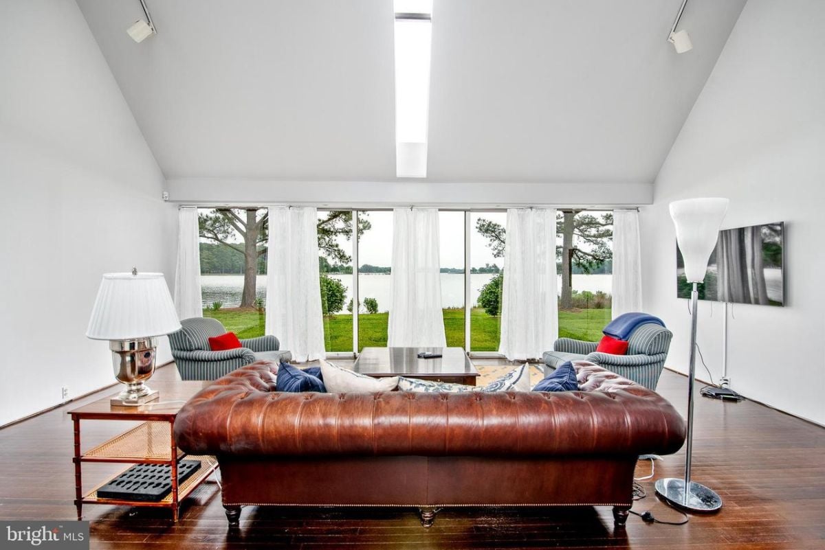 Spacious living room with a large leather couch.
