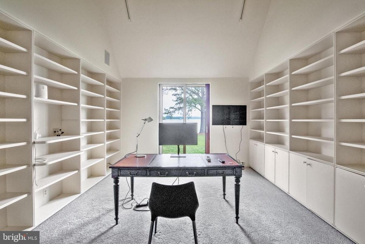 A home office with built in shelves.
