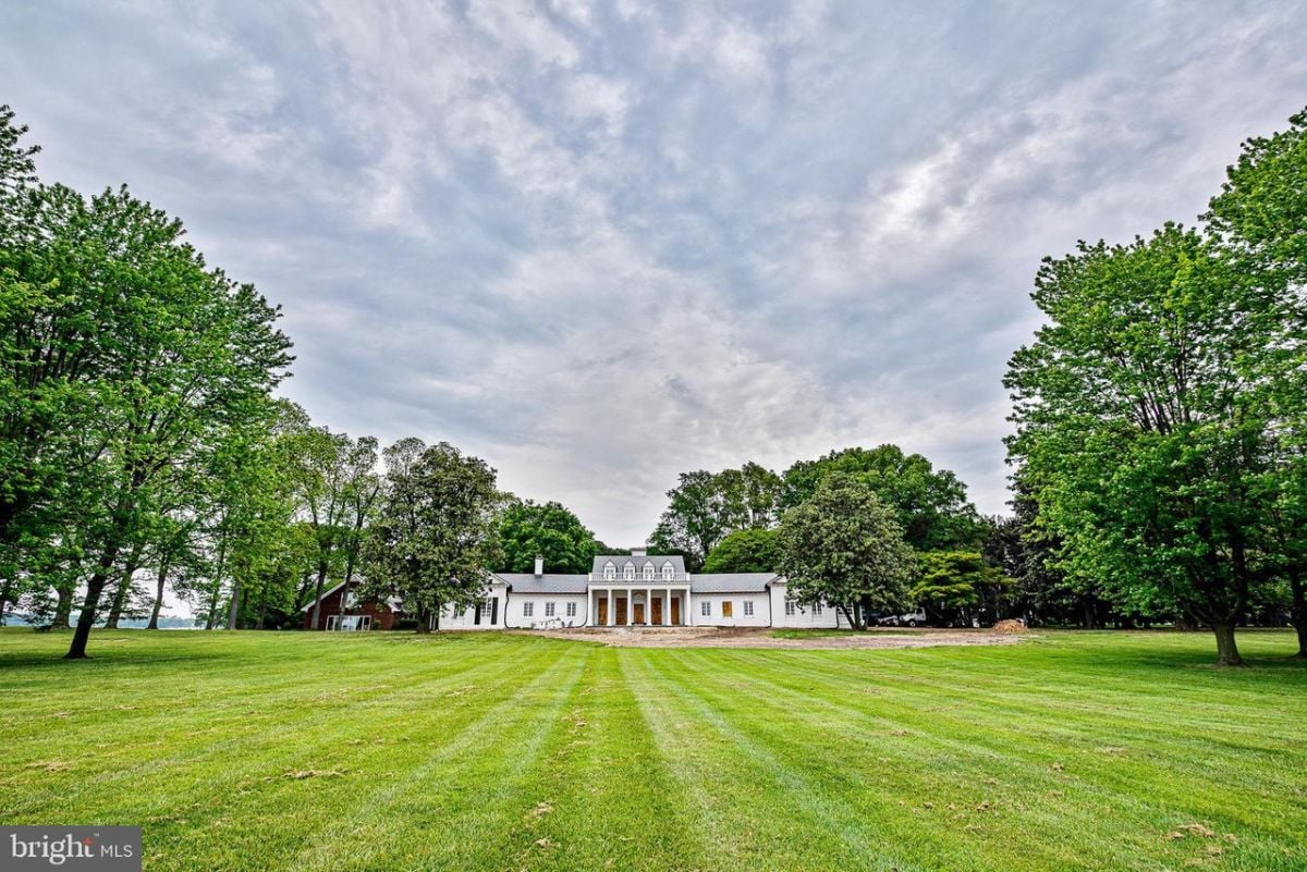 Front view of the house with a huge lawn.
