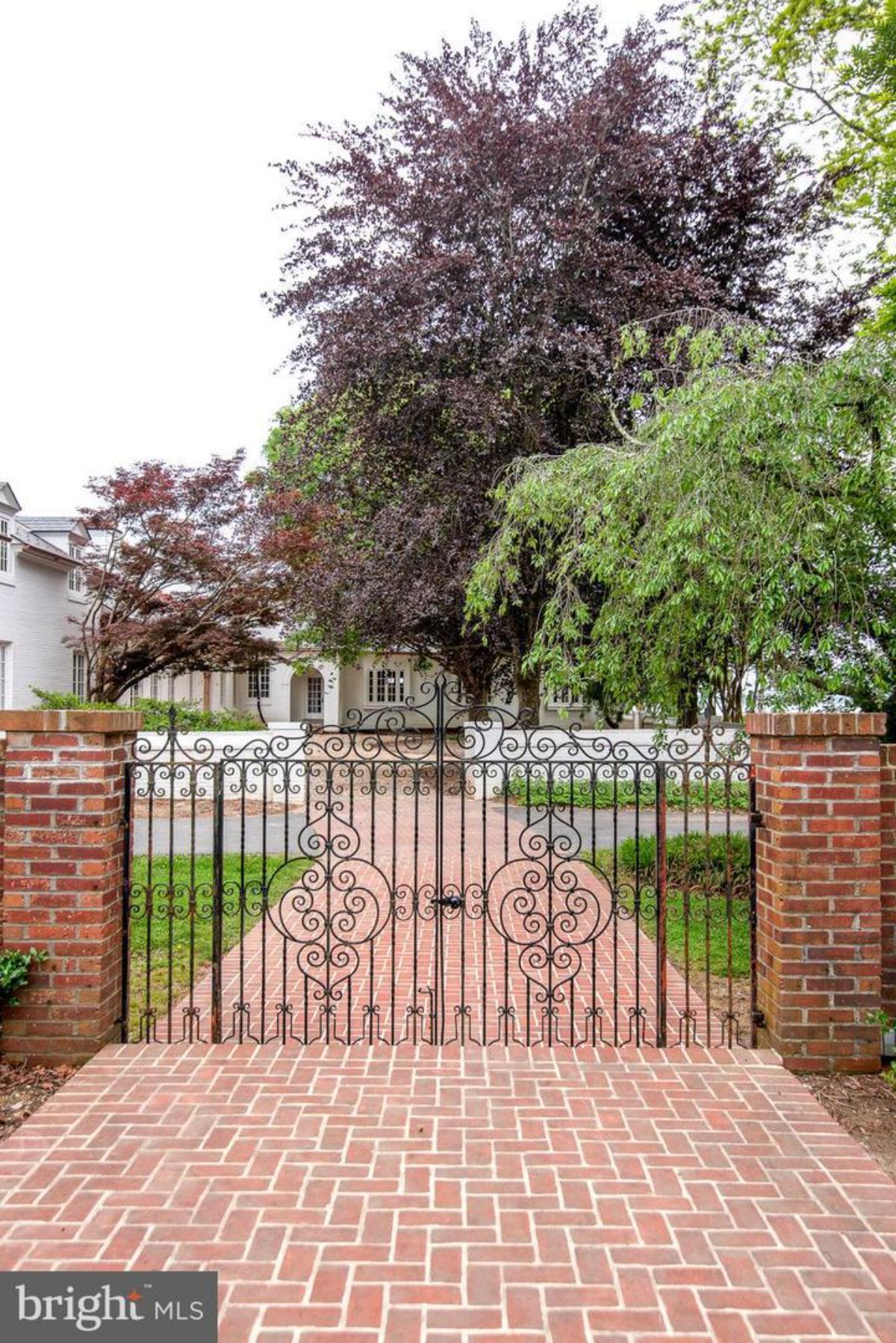 A brick driveway with a gate.