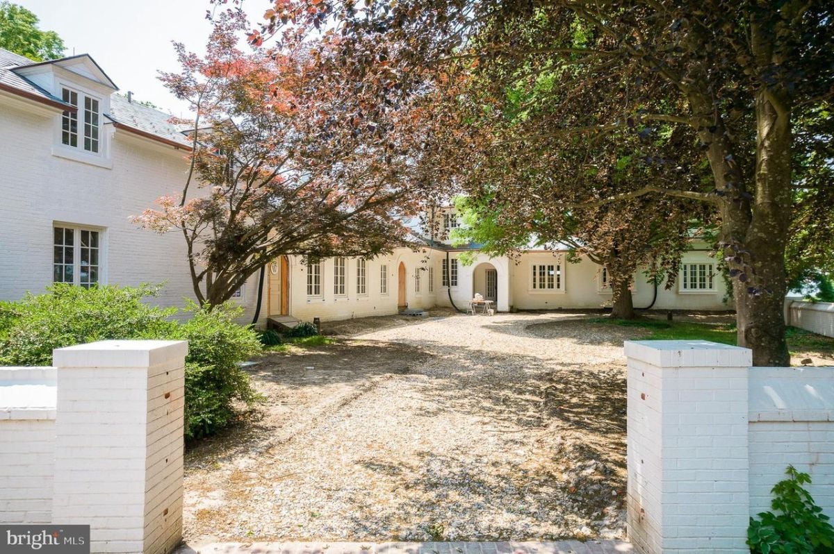 A house with a driveway and trees.