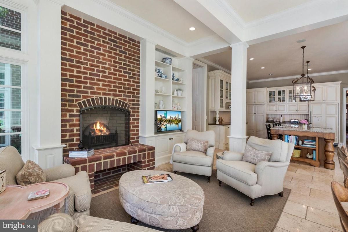 A living room with a fireplace and couches.