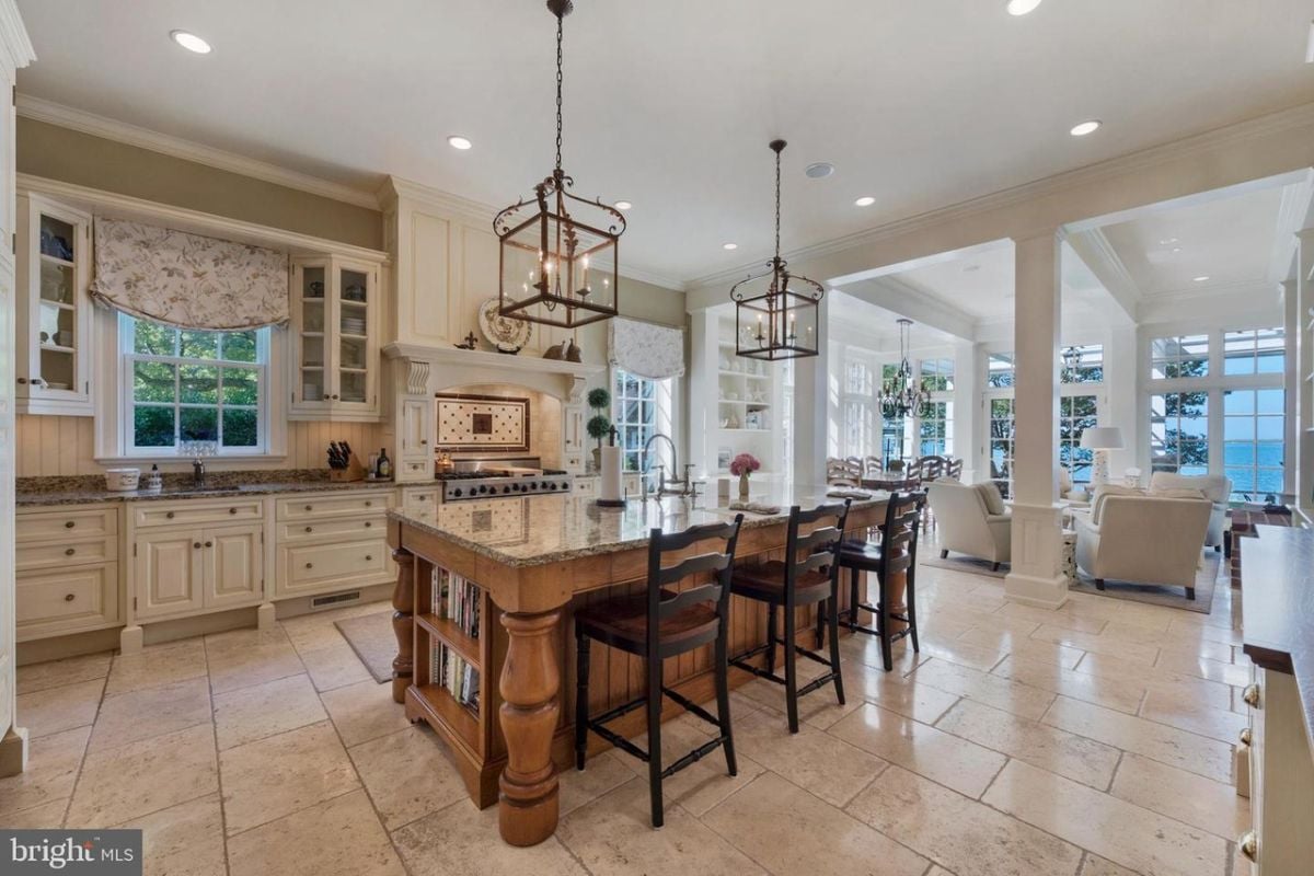A kitchen with a large island and a dining area.