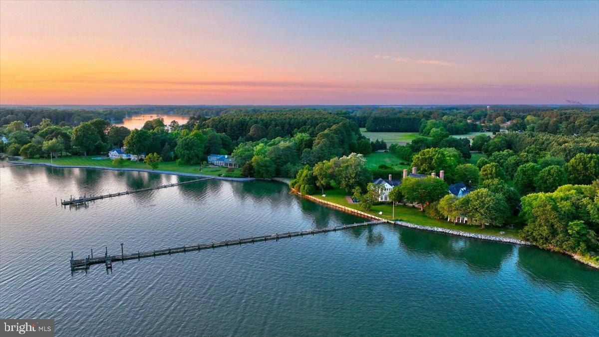 Aerial view of the house with the lake and a dock.