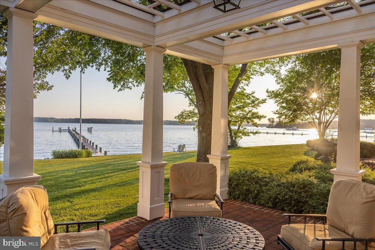 A patio with chairs and a table on it.