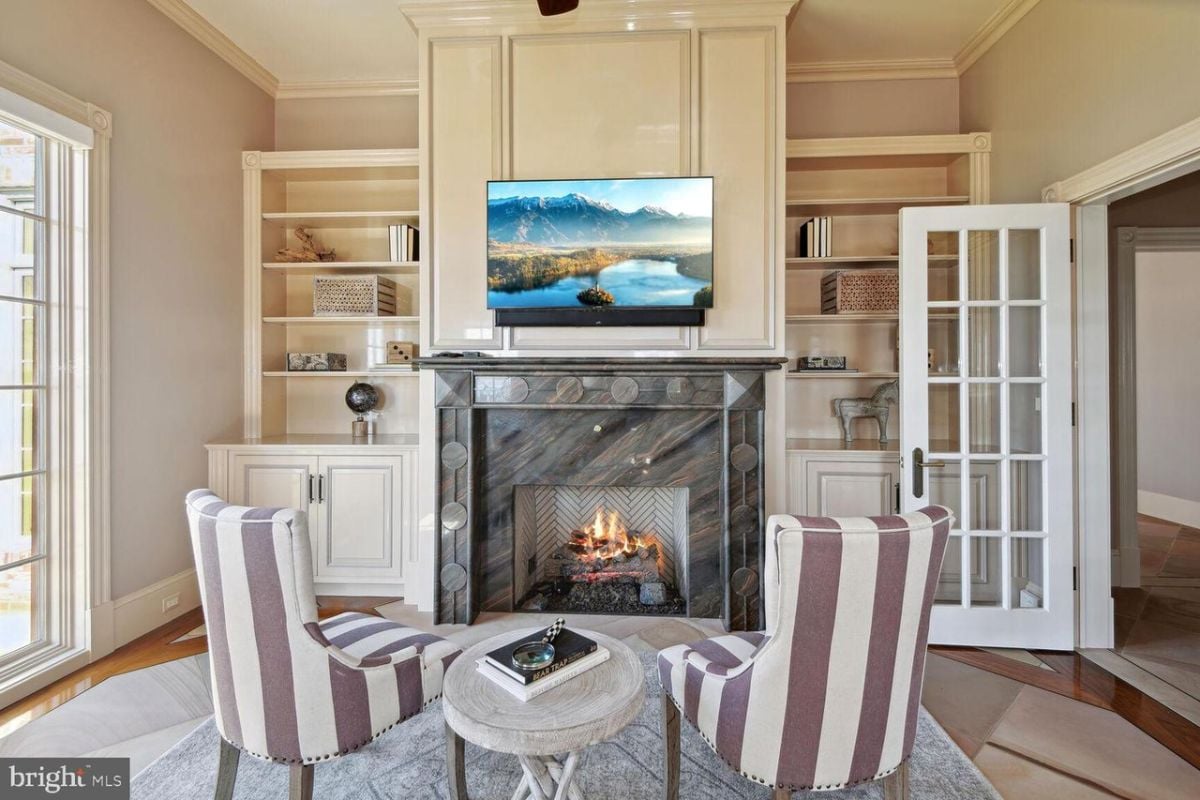 A living room with a fireplace and a television.