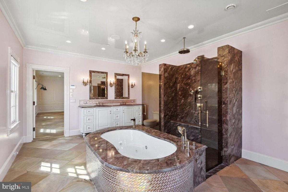 A bathroom with a large tub and a chandelier.