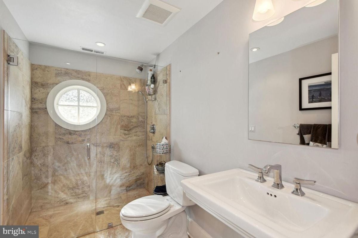 A bathroom with a sink, toilet and shower.