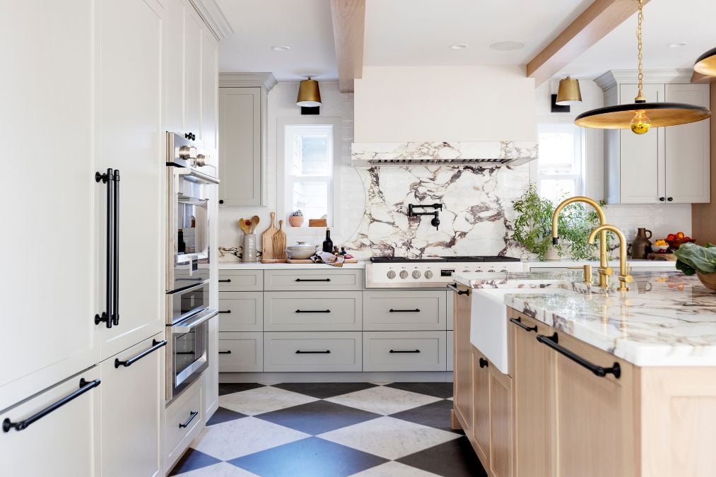 A kitchen with a checkered floor and marble counter tops